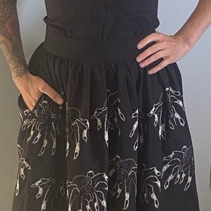 Mini skirt swing style with spiders all around and pockets.